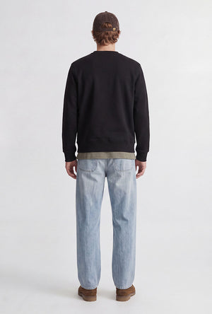 Back image of a model wearing the Rush sweat crew neck sweatshirt in black, by brand Jack&jones