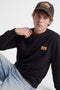 Front image of a model wearing the Rush sweat crew neck sweatshirt in black, by brand Jack&jones