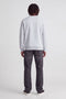 Back image of a model wearing the Rush sweat crew neck sweatshirt in light grey, by brand Jack&jones
