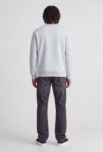 Back image of a model wearing the Rush sweat crew neck sweatshirt in light grey, by brand Jack&jones