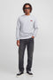 Front image of a model wearing the Rush sweat crew neck sweatshirt in light grey, by brand Jack&jones
