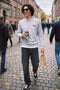 Front image of a model wearing the Rush sweat crew neck sweatshirt in light grey, by brand Jack&jones