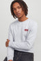 Front image of a model wearing the Rush sweat crew neck sweatshirt in light grey, by brand Jack&jones