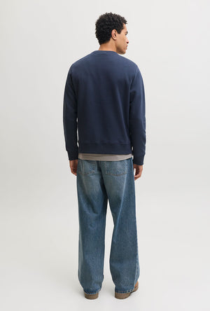Back image of a model wearing the Rush sweat crew neck sweatshirt in navy, by brand Jack&jones