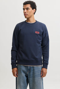 Front image of a model wearing the Rush sweat crew neck sweatshirt in navy, by brand Jack&jones