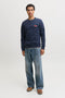 Front image of a model wearing the Rush sweat crew neck sweatshirt in navy, by brand Jack&jones