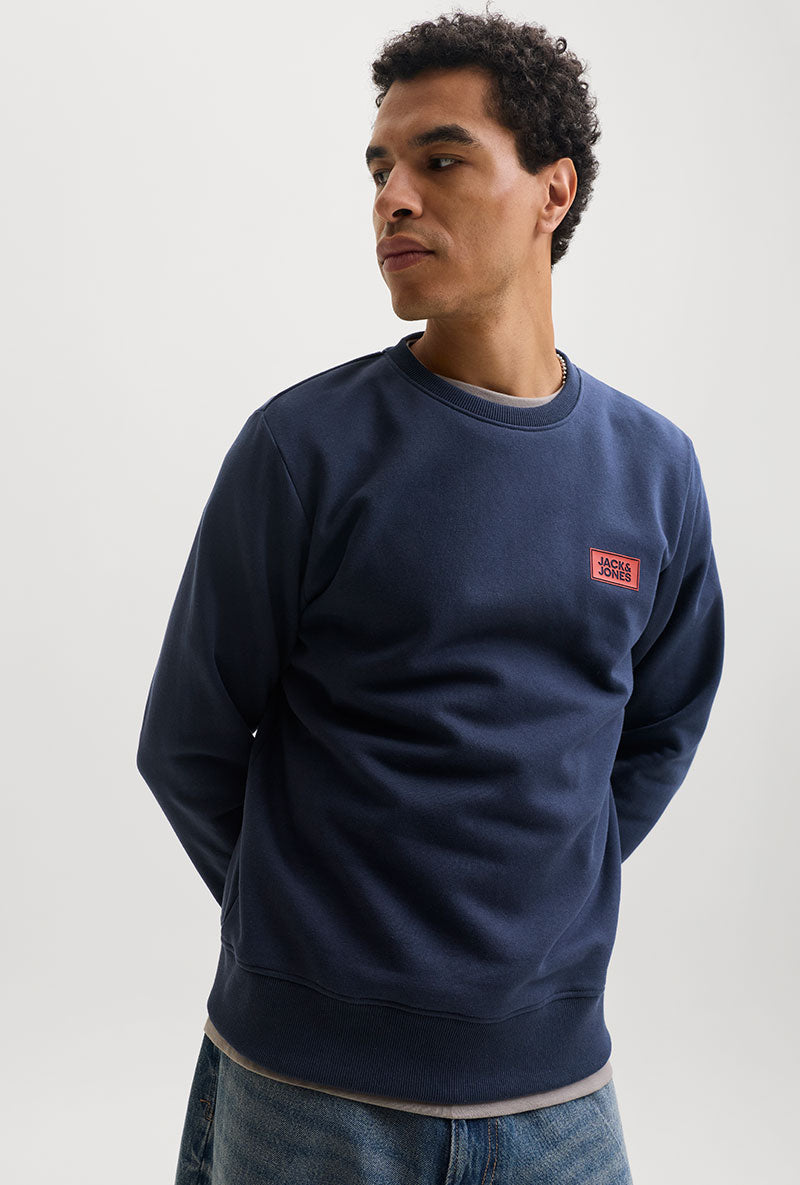 Front image of a model wearing Rush sweat crew neck sweatshirt in navy, by brand Jack&jones