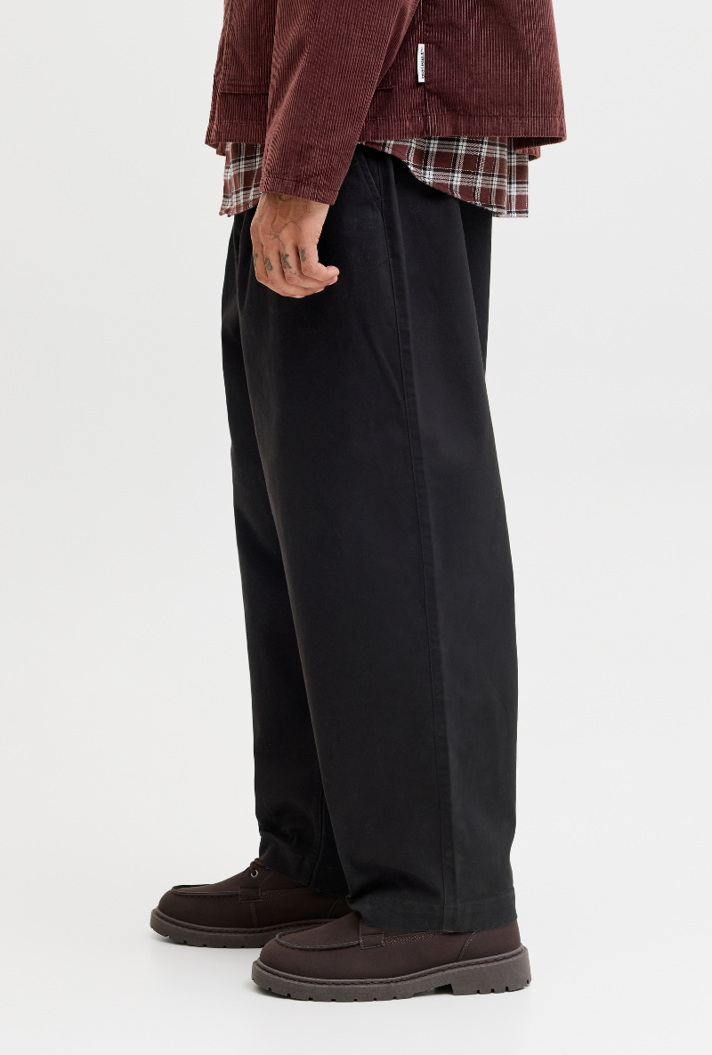 Side image of model wearing Jack and jones stevan dylan jogger in black, by brand Jack&jones