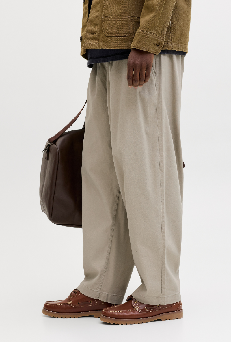 Side image of a model wearing Jack and jones stevan dylan jogger in stone, by brand Jack&jones