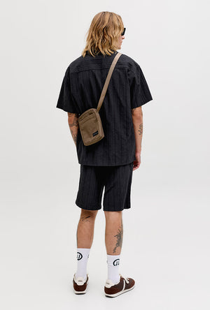 Back image of a model wearing the Tyson resort shirt in black, by brand Jack&jones