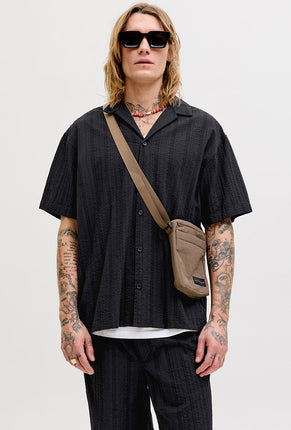Front image of a model wearing Tyson resort shirt in black, by brand Jack&jones