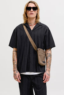 Front image of a model wearing the Tyson resort shirt in black, by brand Jack&jones