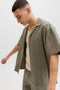 Front image of a model wearing the Tyson resort shirt in khaki, by brand Jack&jones
