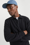 Front image of a model wearing the Jack and jones bradley sweat polo in black, by brand Jack&jones