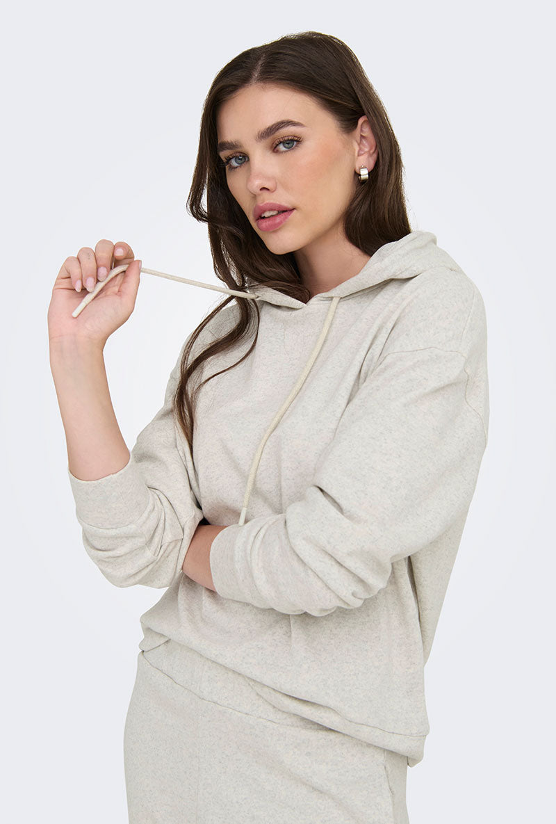 Front image of a model wearing Amalfi life ls hood in oat, by brand Jacqueline de yong
