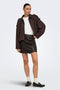 Front image of a model wearing the Ella pu mini skirt in black, by brand Jacqueline de yong