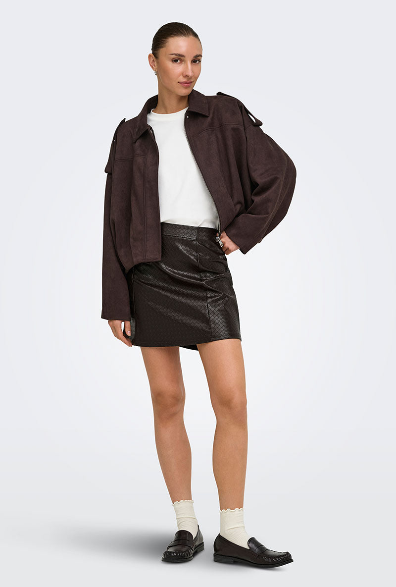 Front image of a model wearing Ella pu mini skirt in black, by brand Jacqueline de yong