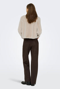 Back image of a model wearing the Macy faux fur jacket in beige, by brand Jacqueline de yong