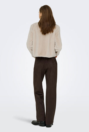 Back image of a model wearing the Macy faux fur jacket in beige, by brand Jacqueline de yong