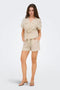 Front image of a model wearing the Mille mw shorts in beige, by brand Jacqueline de yong