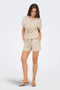 Front image of a model wearing the Mille ss zip shirt in beige, by brand Jacqueline de yong