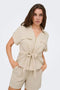 Front image of a model wearing the Mille ss zip shirt in beige, by brand Jacqueline de yong