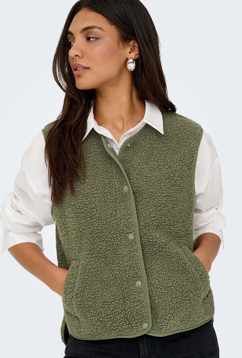 Front image of a model wearing Simina teddy waistcoat in olive, by brand Jacqueline de yong