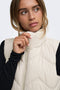 Front image of a model wearing the Power short waistcoat in beige, by brand Jacqueline de yong