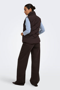 Back image of a model wearing the Power short waistcoat in chocolate, by brand Jacqueline de yong