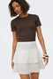 Front image of a model wearing the Theis life hw smock skirt in white, by brand Jacqueline de yong