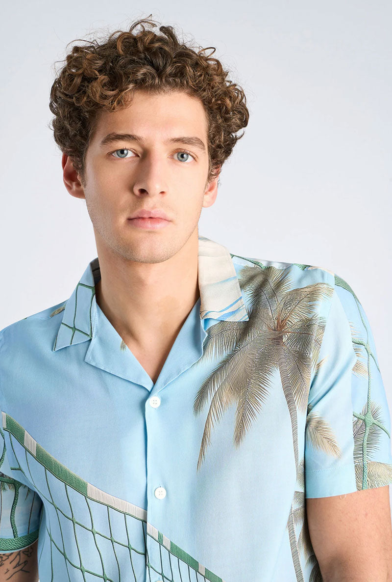 Front image of a model wearing Aop summer viscose shirt in sky, by brand Lindbergh