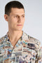 Front image of a model wearing the Aop vintage shirt in all over print, by brand Lindbergh