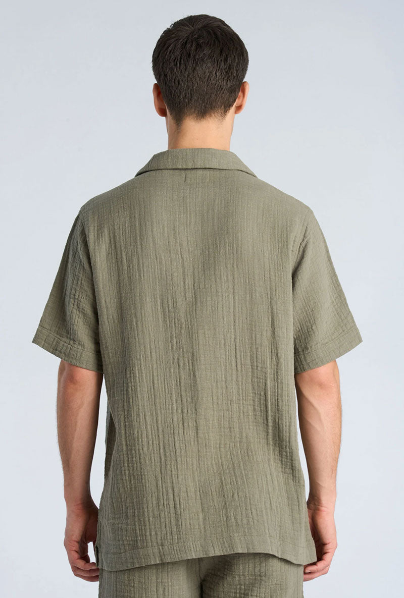 Back image of a model wearing Cotton muslin resort shirt in sage, by brand Lindbergh