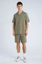 Front image of a model wearing the Cotton muslin resort shirt in sage, by brand Lindbergh