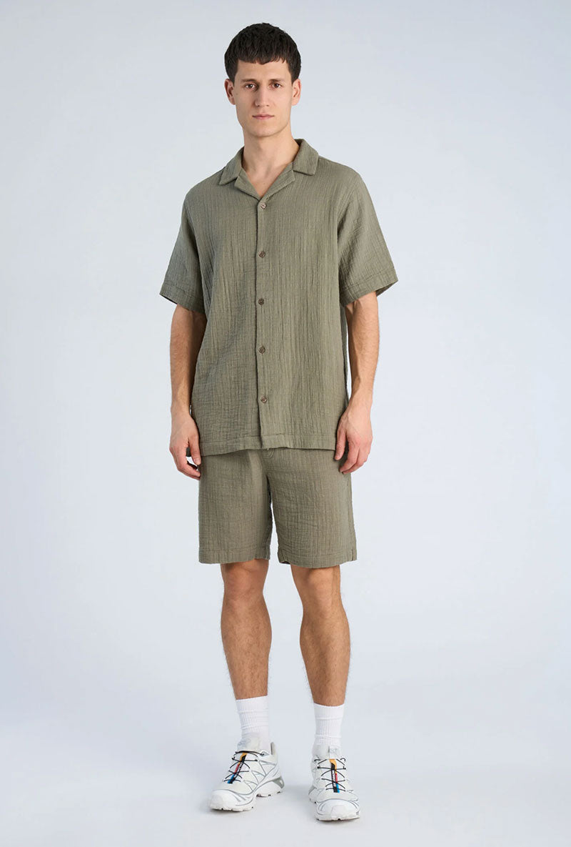 Front image of a model wearing Cotton muslin resort shirt in sage, by brand Lindbergh