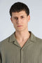 Front image of a model wearing the Cotton muslin resort shirt in sage, by brand Lindbergh