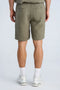 Back image of a model wearing the Cotton muslin shorts in sage, by brand Lindbergh