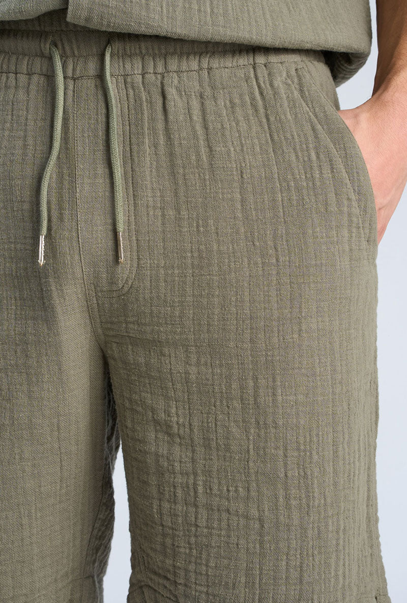 Front image of a model wearing Cotton muslin shorts in sage, by brand Lindbergh