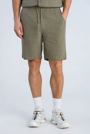 Front image of a model wearing the Cotton muslin shorts in sage, by brand Lindbergh