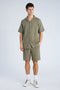 Front image of a model wearing the Cotton muslin shorts in sage, by brand Lindbergh