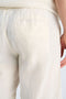 Back image of a model wearing the Cotton muslin shorts in off white, by brand Lindbergh