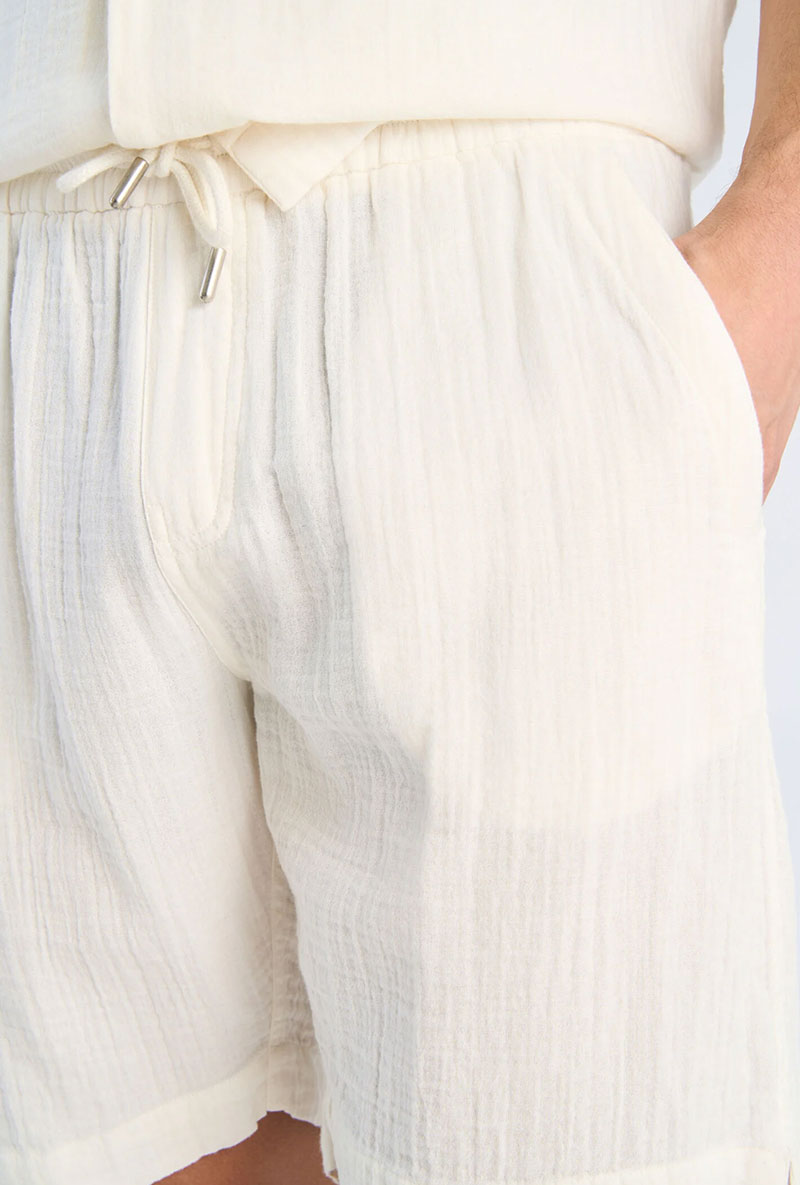 Front image of a model wearing Cotton muslin shorts in off white, by brand Lindbergh