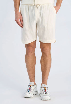 Front image of a model wearing Cotton muslin shorts in off white, by brand Lindbergh