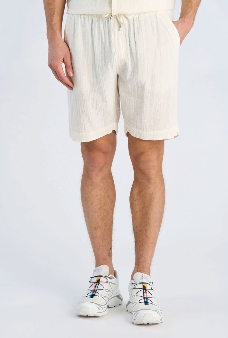 Front image of a model wearing Cotton muslin shorts in off white, by brand Lindbergh