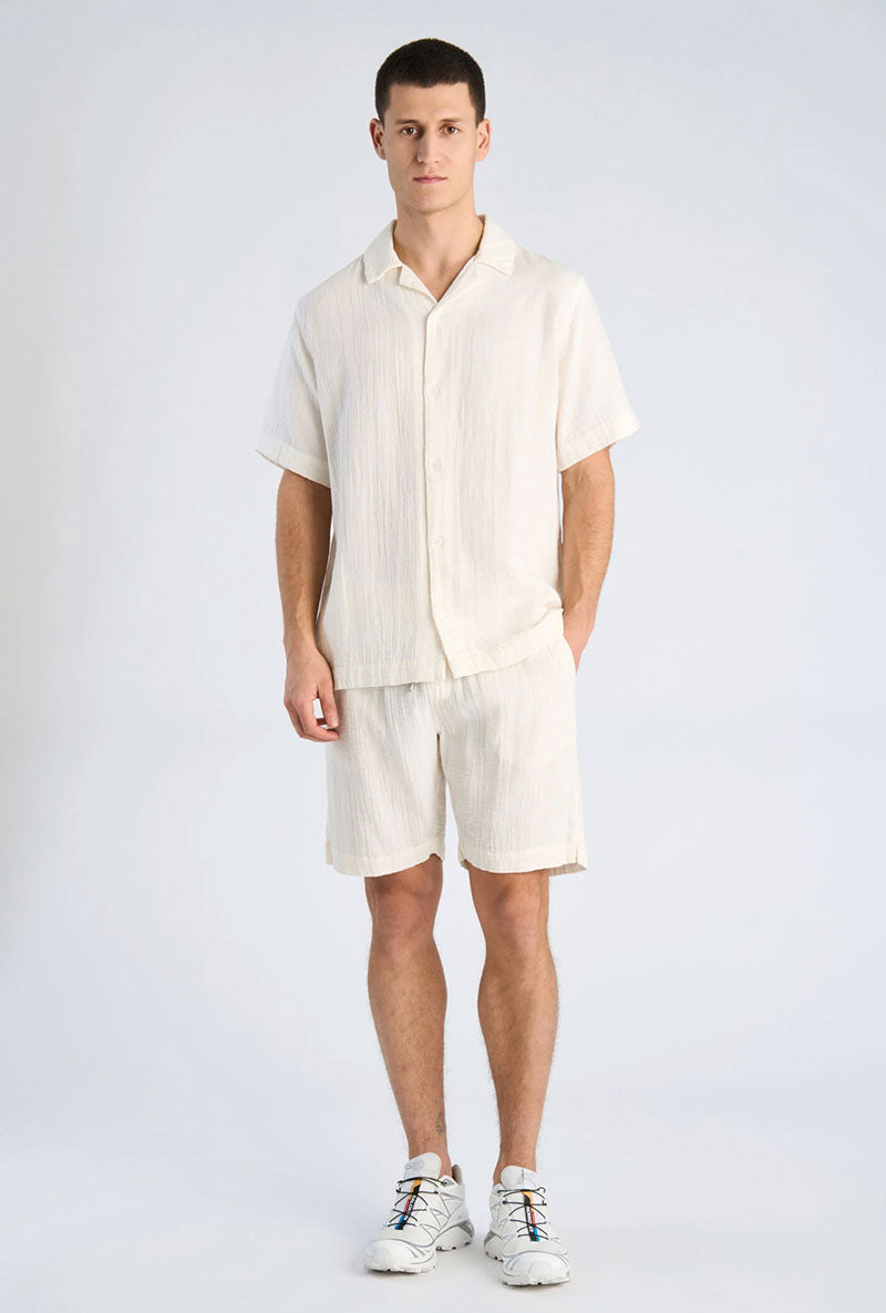 Front image of a model wearing Cotton muslin shorts in off white, by brand Lindbergh