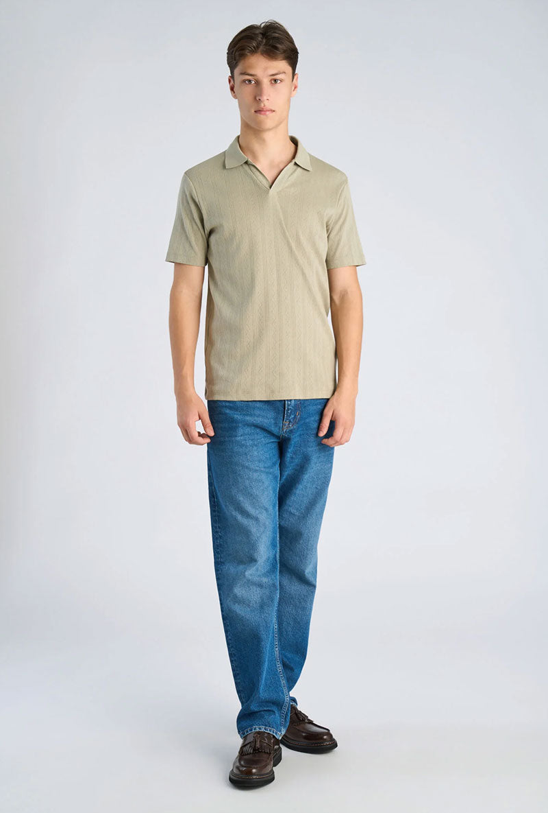 Front image of a model wearing Jacquard vneck polo in olive, by brand Lindbergh