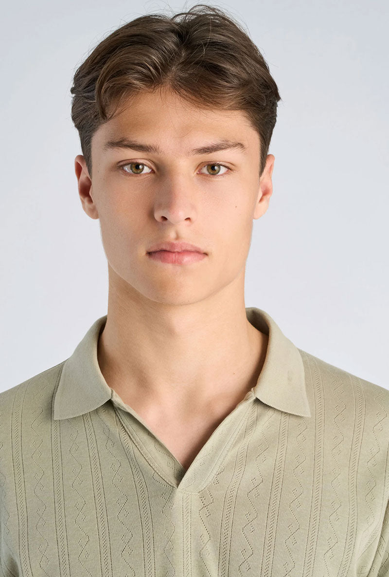 Front image of a model wearing Jacquard vneck polo in olive, by brand Lindbergh