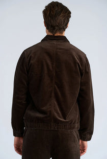 Back image of a model wearing the Seersucker corduroy zip jacket in brown, by brand Lindbergh