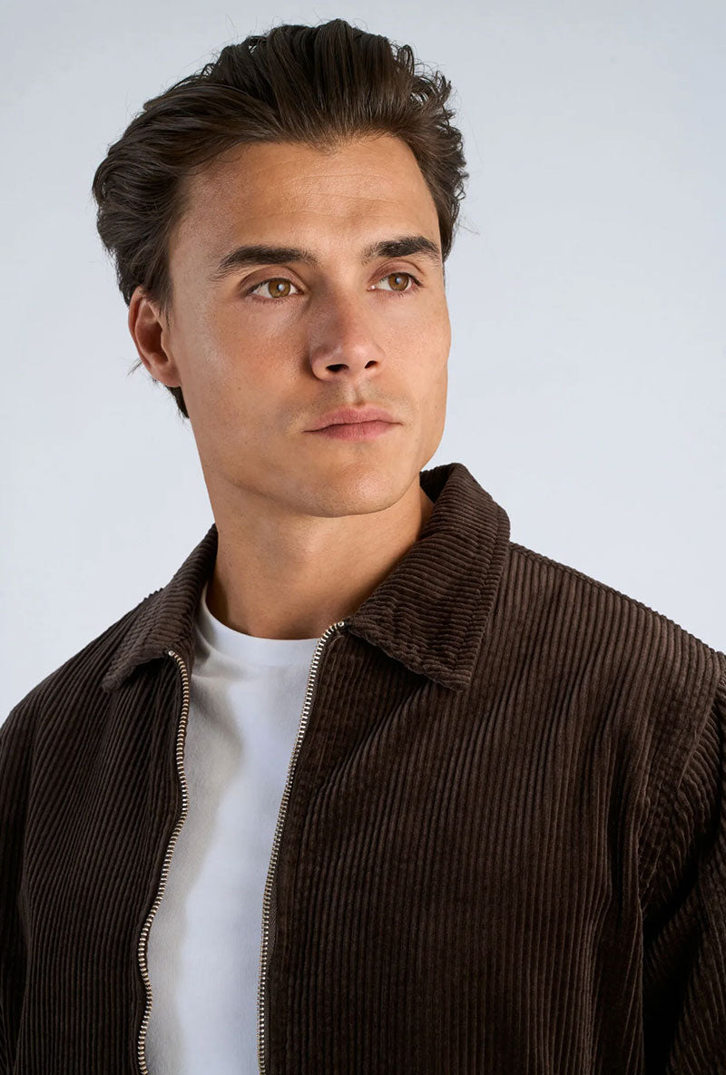 Front image of a model wearing Seersucker corduroy zip jacket in brown, by brand Lindbergh