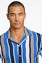 Front image of a model wearing the Bold stripe viscose shirt in blue, by brand Lindbergh